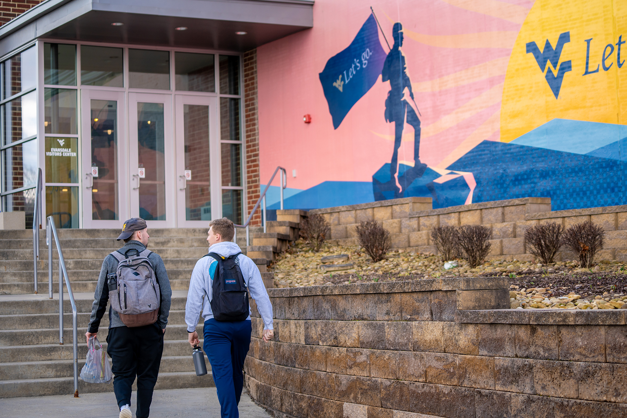 Two students walking towards the entrance of Evansdale Crossing